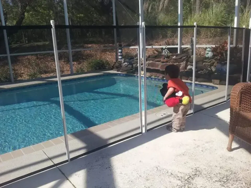 toddler outside of pool safety fence