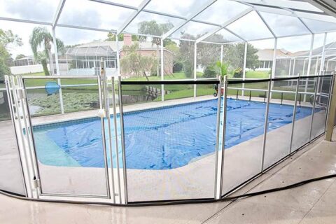 A pool surrounded by a safety fence, ensuring secure access to the water area.