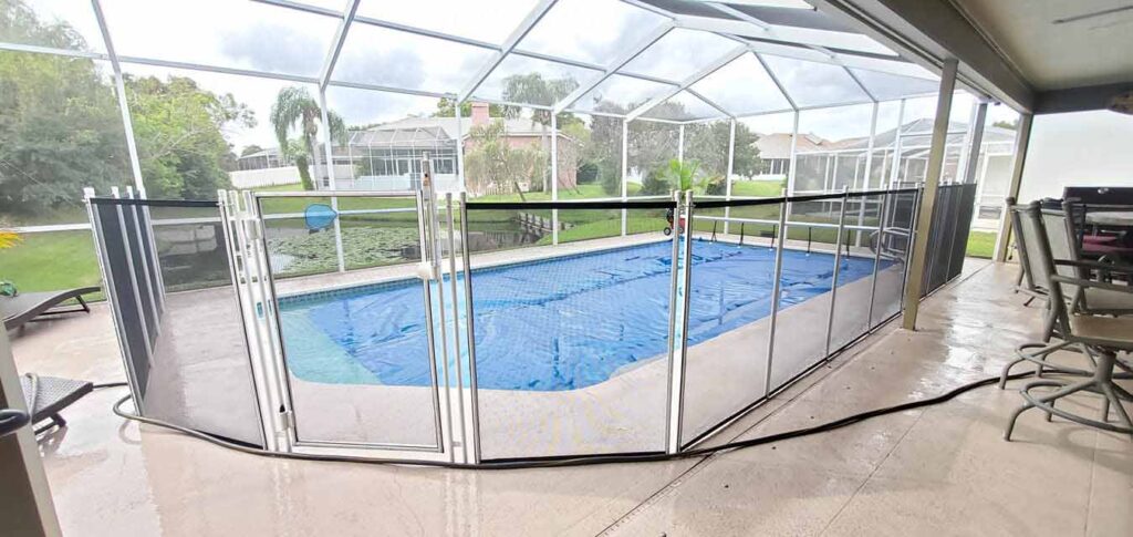 A pool surrounded by a safety fence, ensuring secure access to the water area.